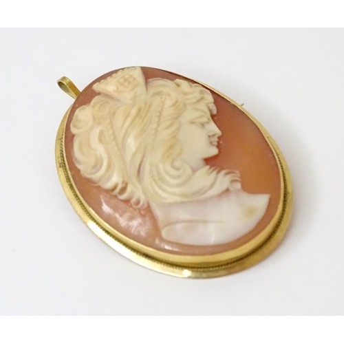 715 - A carved cameo brooch within a gold mount. Approx 1 1/2