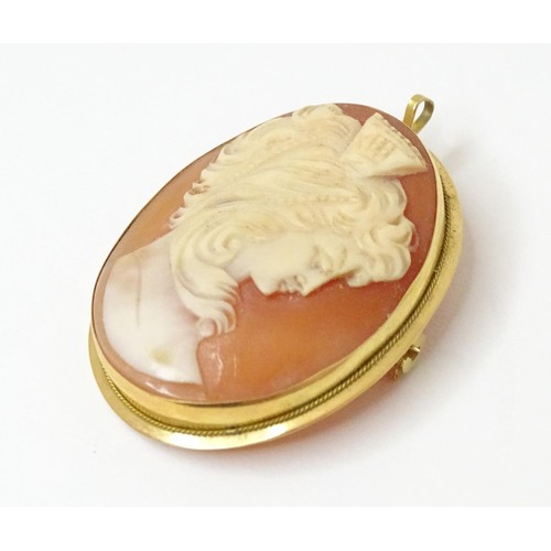 715 - A carved cameo brooch within a gold mount. Approx 1 1/2