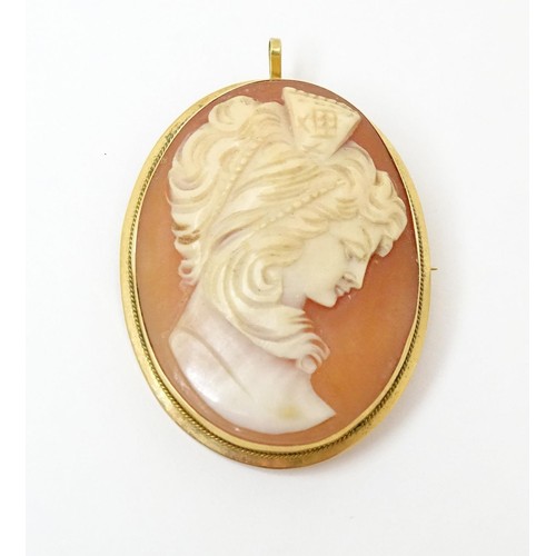 715 - A carved cameo brooch within a gold mount. Approx 1 1/2