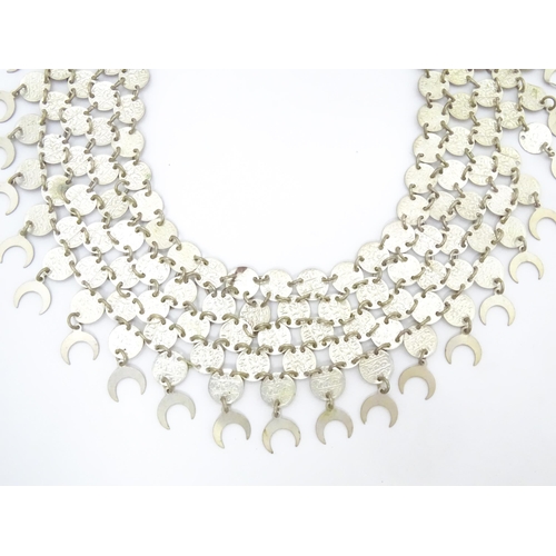 734 - A Persian / Indian style white metal necklace / chocker collar formed of discs with script and cresc... 