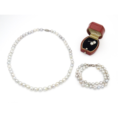 737 - Pearl jewellery comprising a two strand bracelet with silver clasp, a necklace with silver clasp and... 