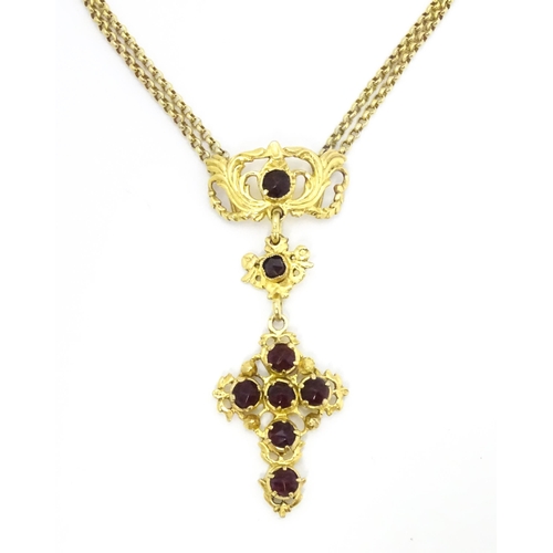 738 - A silver gilt pendant necklace of cross form with garnet coloured paste stones approx 16 1/2