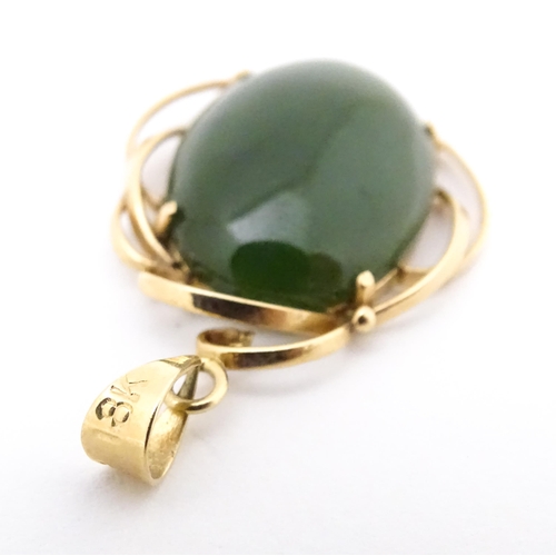 742 - A yellow metal pendant set with green stone cabochon. Together with a pair of 9ct gold pearl earring... 