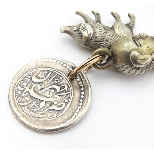 748 - Three assorted charms to include a white metal model of a pig / boar, a buddha head and a coin fob f... 