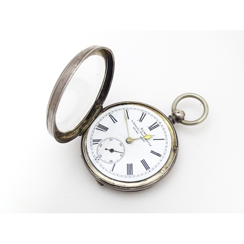 758 - A Swiss .925 silver pocket watch, the white enamel dial with subsidiary seconds dial at 6, signed  '... 