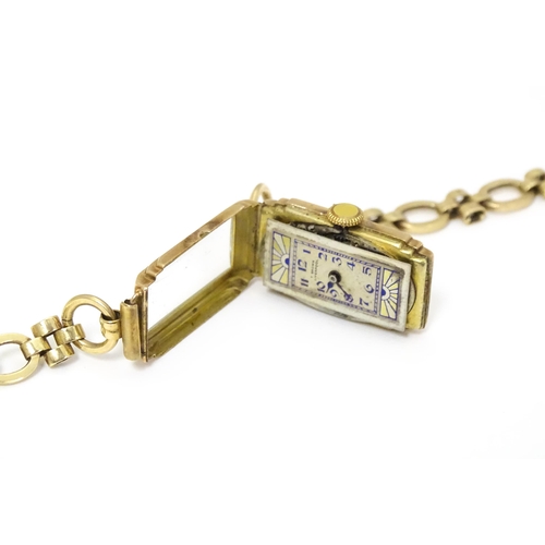767 - A 9ct gold cased Art Deco ladies wristwatch, the dial with blue and yellow sunburnt decoration and b... 