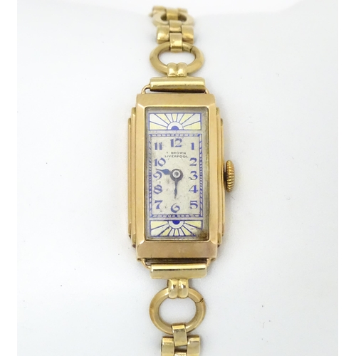 767 - A 9ct gold cased Art Deco ladies wristwatch, the dial with blue and yellow sunburnt decoration and b... 