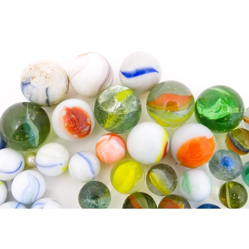 837 - Toys: A quantity of marbles, many with colours twists, etc. Largest approx. 1