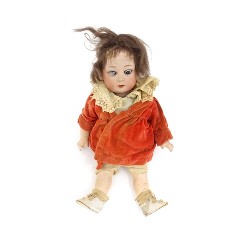 839A - Toy: A German Gebruder Heubach doll with a bisque head and composite body. Approx. 13 1/4