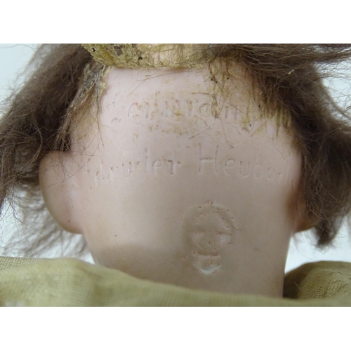 839A - Toy: A German Gebruder Heubach doll with a bisque head and composite body. Approx. 13 1/4