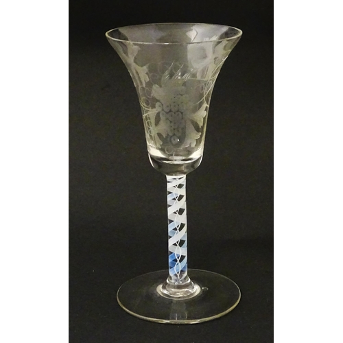 218 - A 19thC pedestal drinking glass with double air twist and etched bird and fruiting vine detail. Appr... 