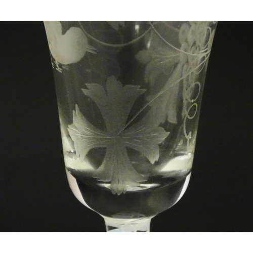 218 - A 19thC pedestal drinking glass with double air twist and etched bird and fruiting vine detail. Appr... 