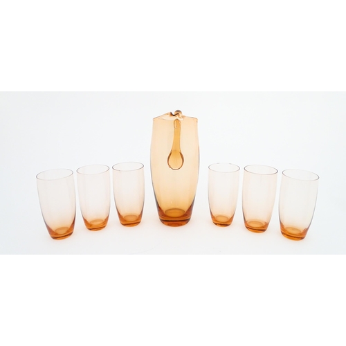 221 - A peach glass lemonade set comprising jug and six glasses. Jug approx. 9 1/2