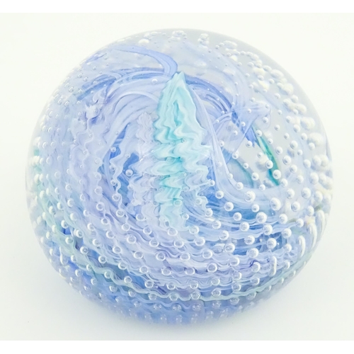 223 - An art glass paperweight with swirled and bullicante detail. Approx. 3 1/4