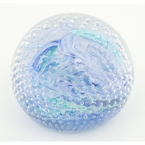 223 - An art glass paperweight with swirled and bullicante detail. Approx. 3 1/4