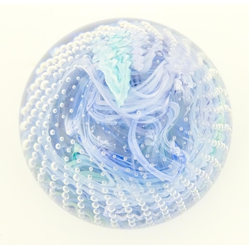 223 - An art glass paperweight with swirled and bullicante detail. Approx. 3 1/4