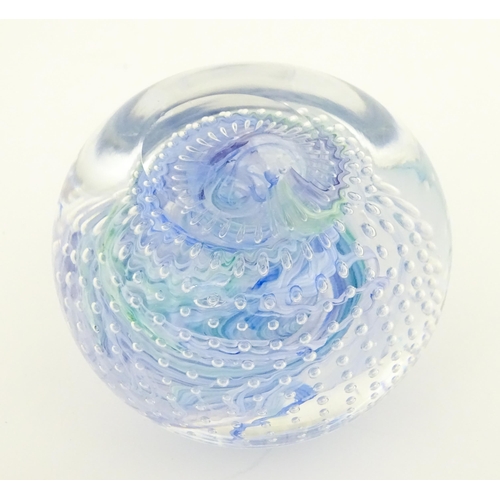 223 - An art glass paperweight with swirled and bullicante detail. Approx. 3 1/4