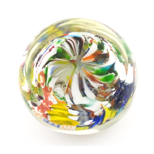 225 - A small glass paperweight with millefiori decoration. Approx. 2 1/2