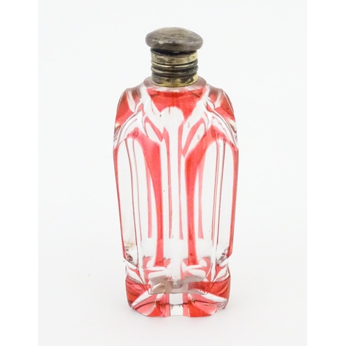 228 - A Bohemian glass scent / perfume bottle with red detail and a Continental silver gilt lid. Approx. 3... 