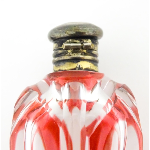 228 - A Bohemian glass scent / perfume bottle with red detail and a Continental silver gilt lid. Approx. 3... 