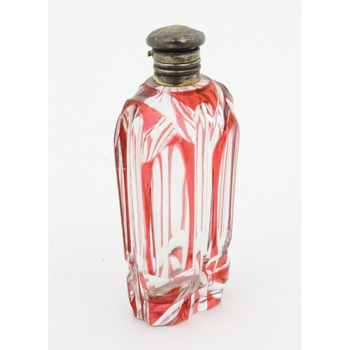 228 - A Bohemian glass scent / perfume bottle with red detail and a Continental silver gilt lid. Approx. 3... 