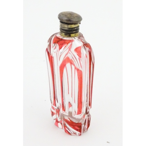 228 - A Bohemian glass scent / perfume bottle with red detail and a Continental silver gilt lid. Approx. 3... 