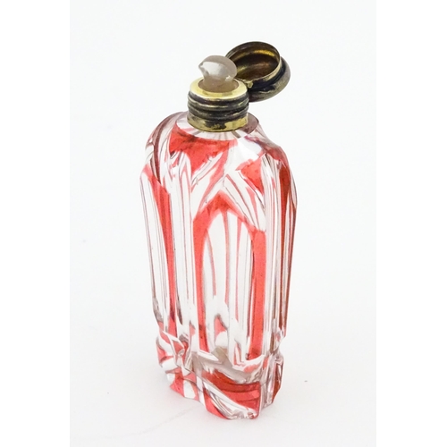 228 - A Bohemian glass scent / perfume bottle with red detail and a Continental silver gilt lid. Approx. 3... 