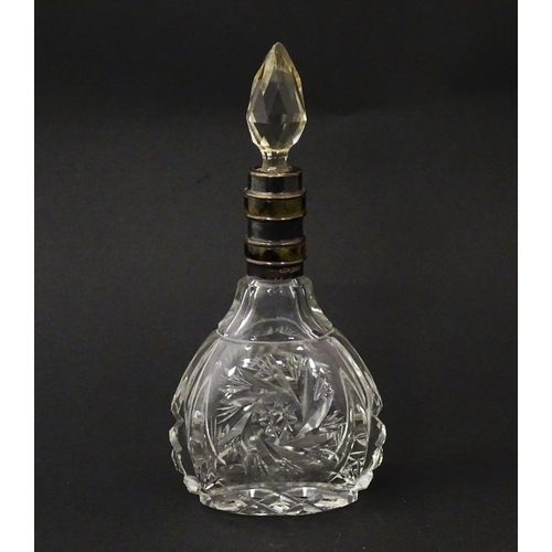 234 - A cut glass scent / perfume bottle and stopper, the silver collar with banded detail and hallmarked ... 