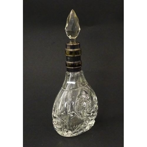 234 - A cut glass scent / perfume bottle and stopper, the silver collar with banded detail and hallmarked ... 