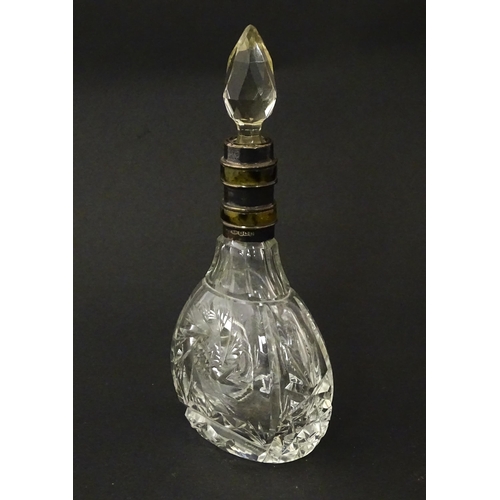 234 - A cut glass scent / perfume bottle and stopper, the silver collar with banded detail and hallmarked ... 