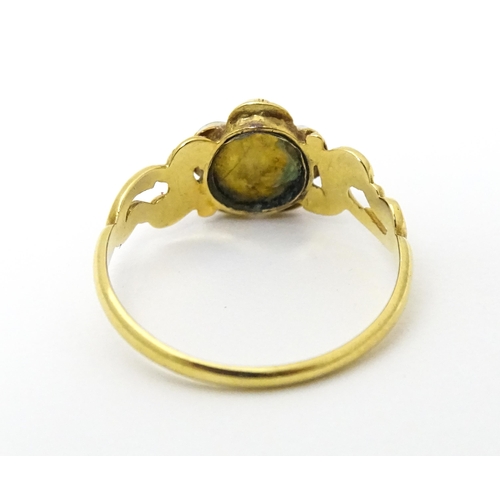 610 - A yellow metal ring set with central diamond bordered by turquoise. Ring size approx K