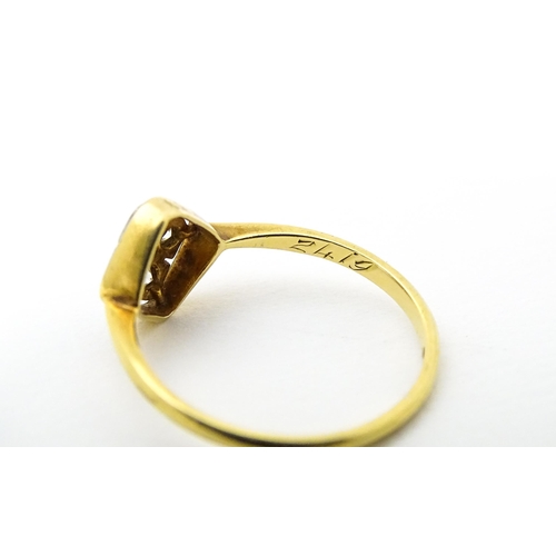 615 - An 18ct gold ring set with four diamonds in an Art Deco geometric setting. Ring size approx. P