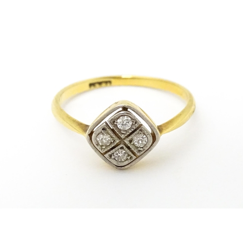 615 - An 18ct gold ring set with four diamonds in an Art Deco geometric setting. Ring size approx. P