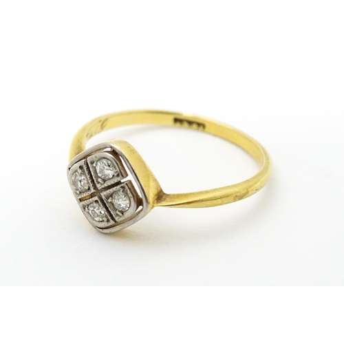 615 - An 18ct gold ring set with four diamonds in an Art Deco geometric setting. Ring size approx. P