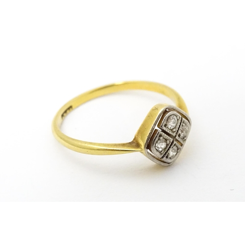 615 - An 18ct gold ring set with four diamonds in an Art Deco geometric setting. Ring size approx. P