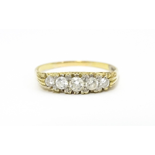 616 - A 9ct gold ring set with five white stones. Ring size approx. S 1/2