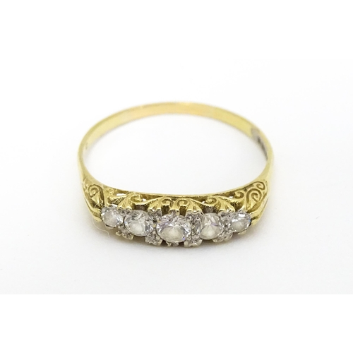 616 - A 9ct gold ring set with five white stones. Ring size approx. S 1/2