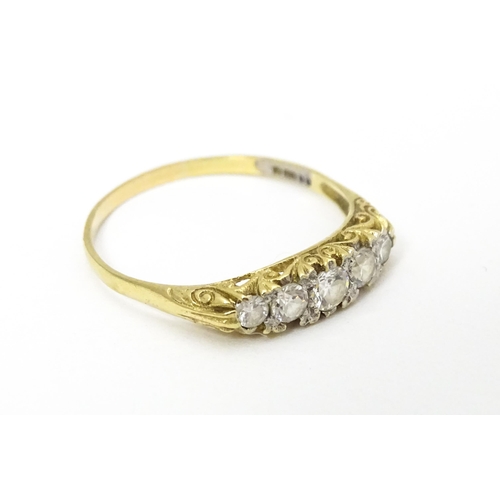 616 - A 9ct gold ring set with five white stones. Ring size approx. S 1/2