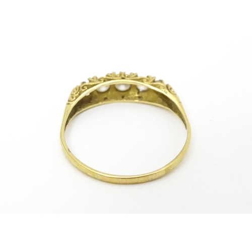 616 - A 9ct gold ring set with five white stones. Ring size approx. S 1/2