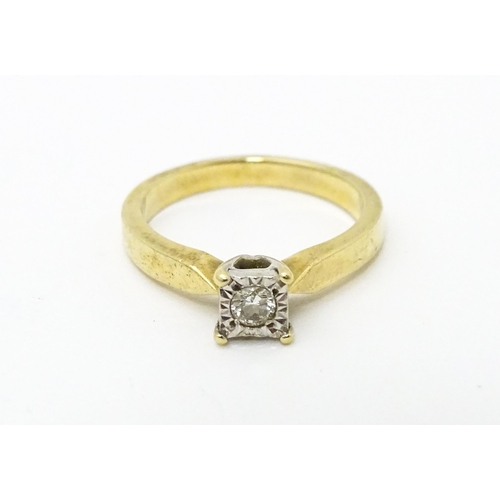 618 - A 9ct gold ring set with central illusion set diamond solitaire. Ring size approx. J