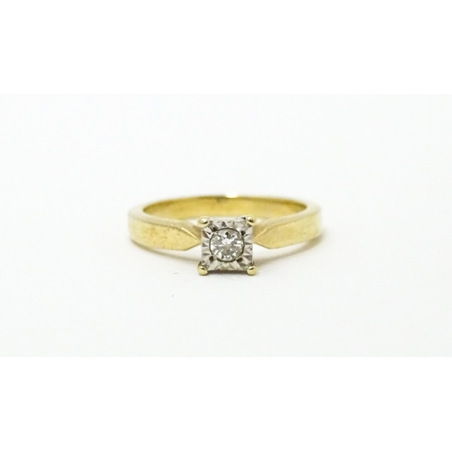 618 - A 9ct gold ring set with central illusion set diamond solitaire. Ring size approx. J