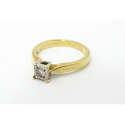 618 - A 9ct gold ring set with central illusion set diamond solitaire. Ring size approx. J