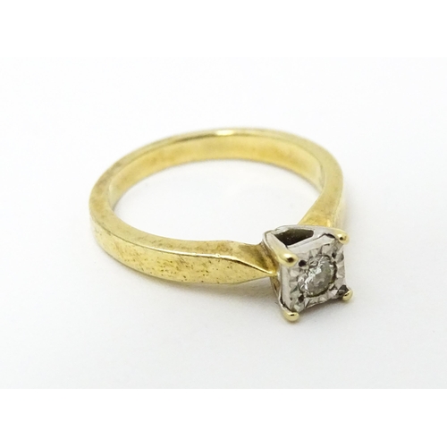 618 - A 9ct gold ring set with central illusion set diamond solitaire. Ring size approx. J