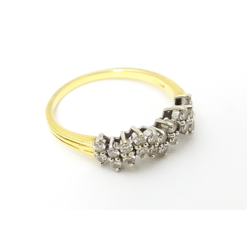 620 - An 18ct gold ring set with a profusion of diamonds. Ring size approx. Q