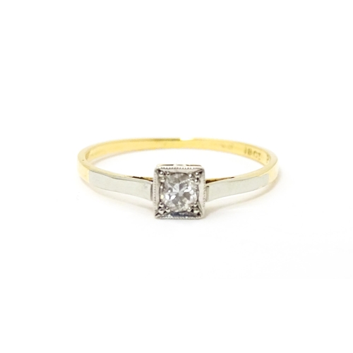 626 - An 18ct gold ring with platinum set diamond solitaire. Ring size approx. Q