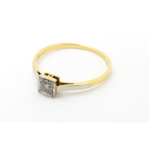 626 - An 18ct gold ring with platinum set diamond solitaire. Ring size approx. Q