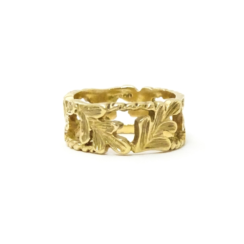 627 - A 9ct gold ring with oak leaf detail. Ring size approx. K