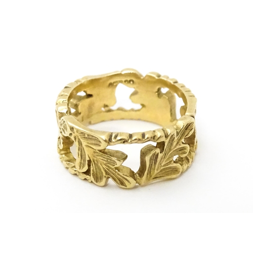 627 - A 9ct gold ring with oak leaf detail. Ring size approx. K