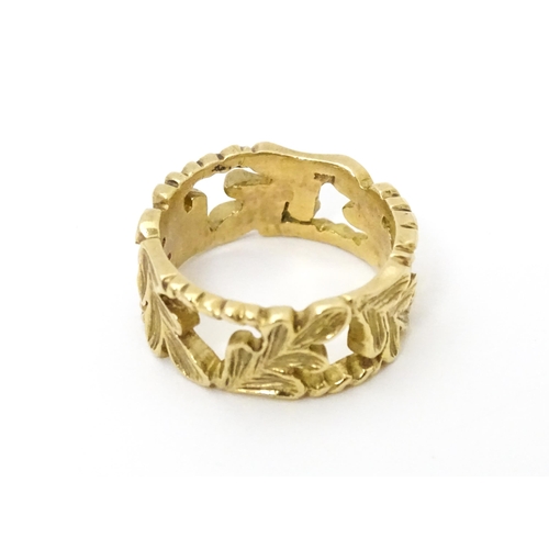 627 - A 9ct gold ring with oak leaf detail. Ring size approx. K