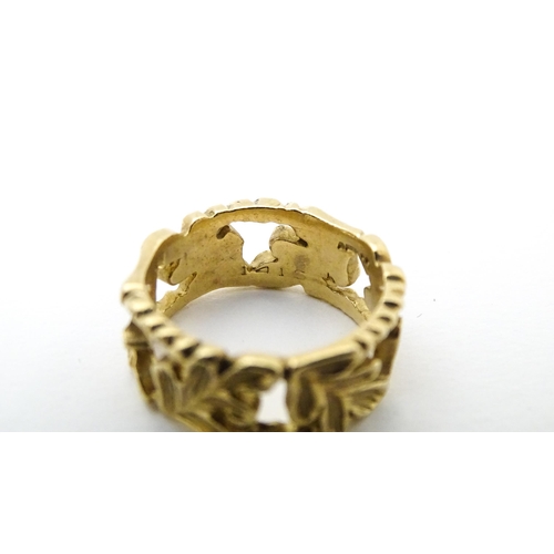 627 - A 9ct gold ring with oak leaf detail. Ring size approx. K